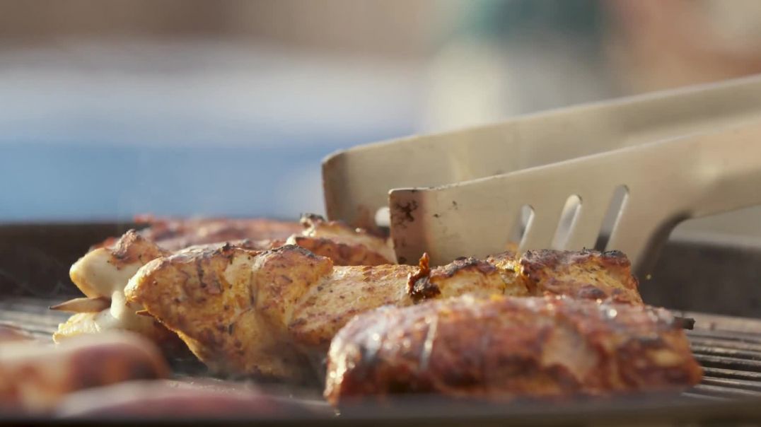 Flipping chicken on grill