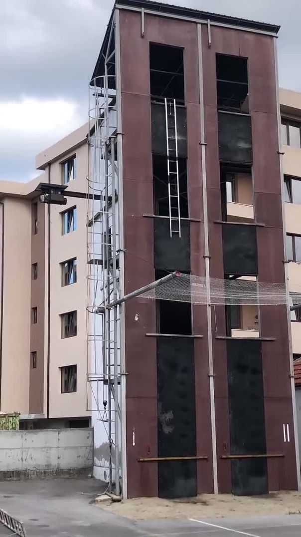 Man Deftly Ascends Building With Ladder