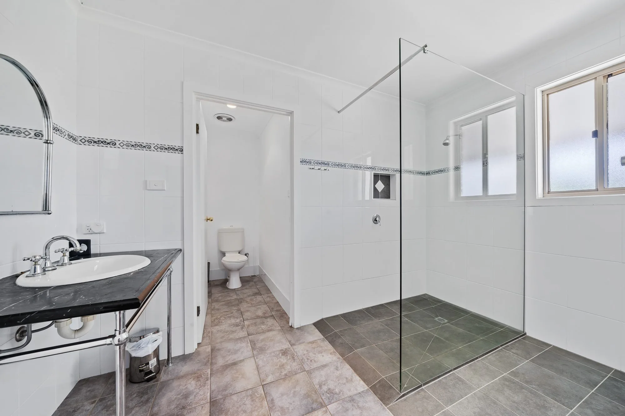 Ensuite bathroom with walk-in glass shower and marble vanity