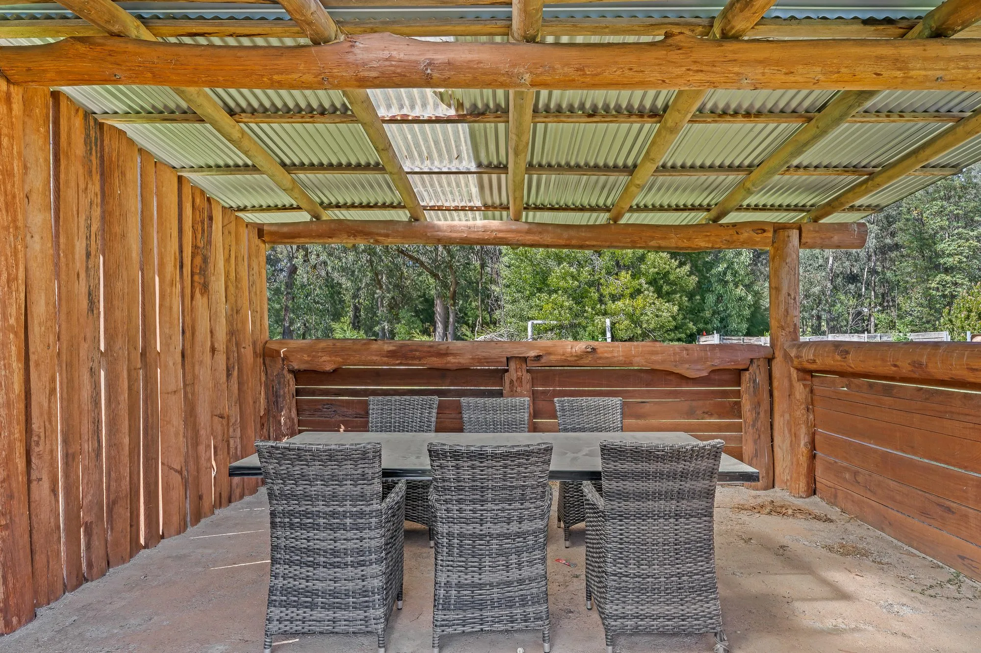 Covered outdoor dining pavilion among the trees