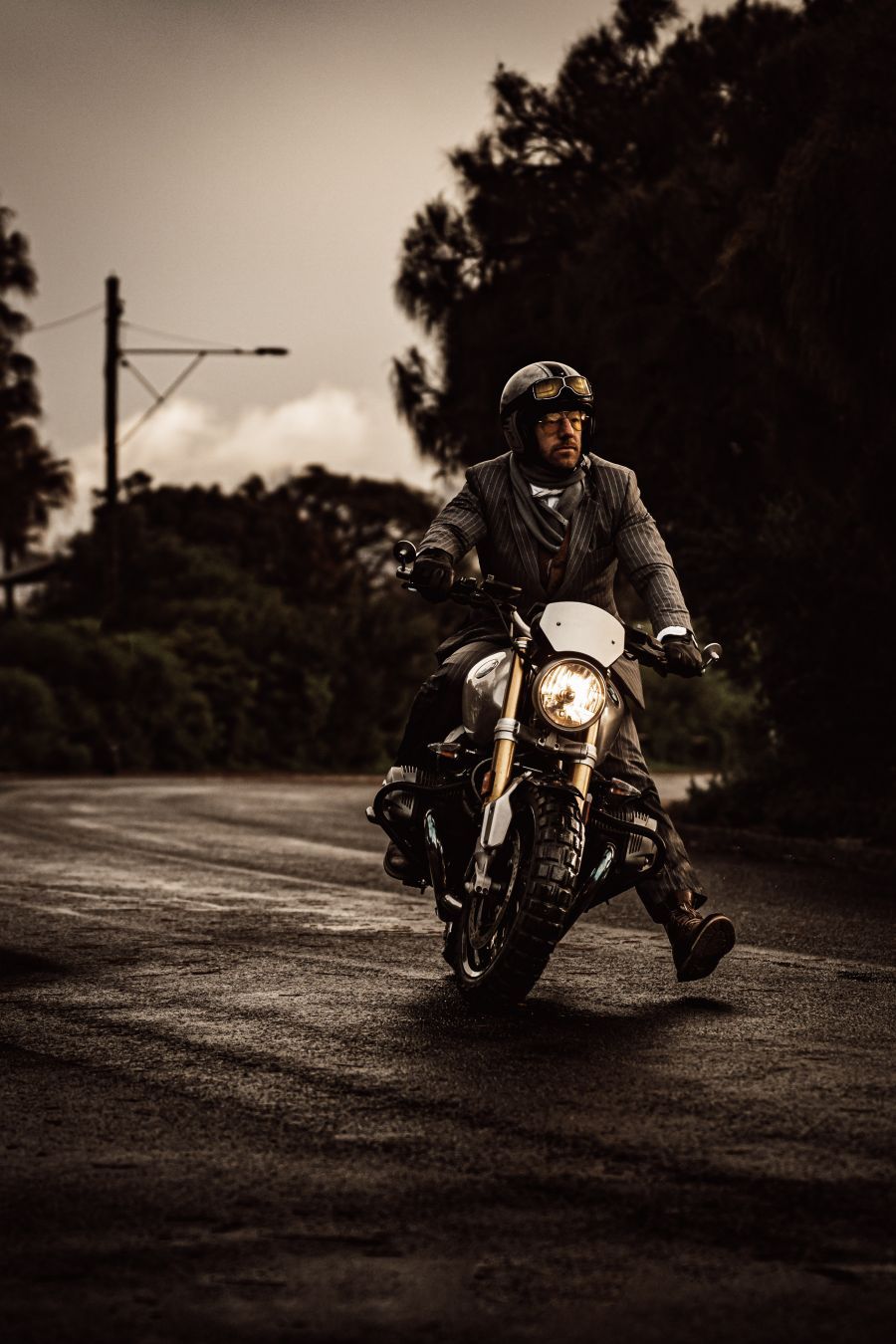 A distinguished gentleman on a motorbike.