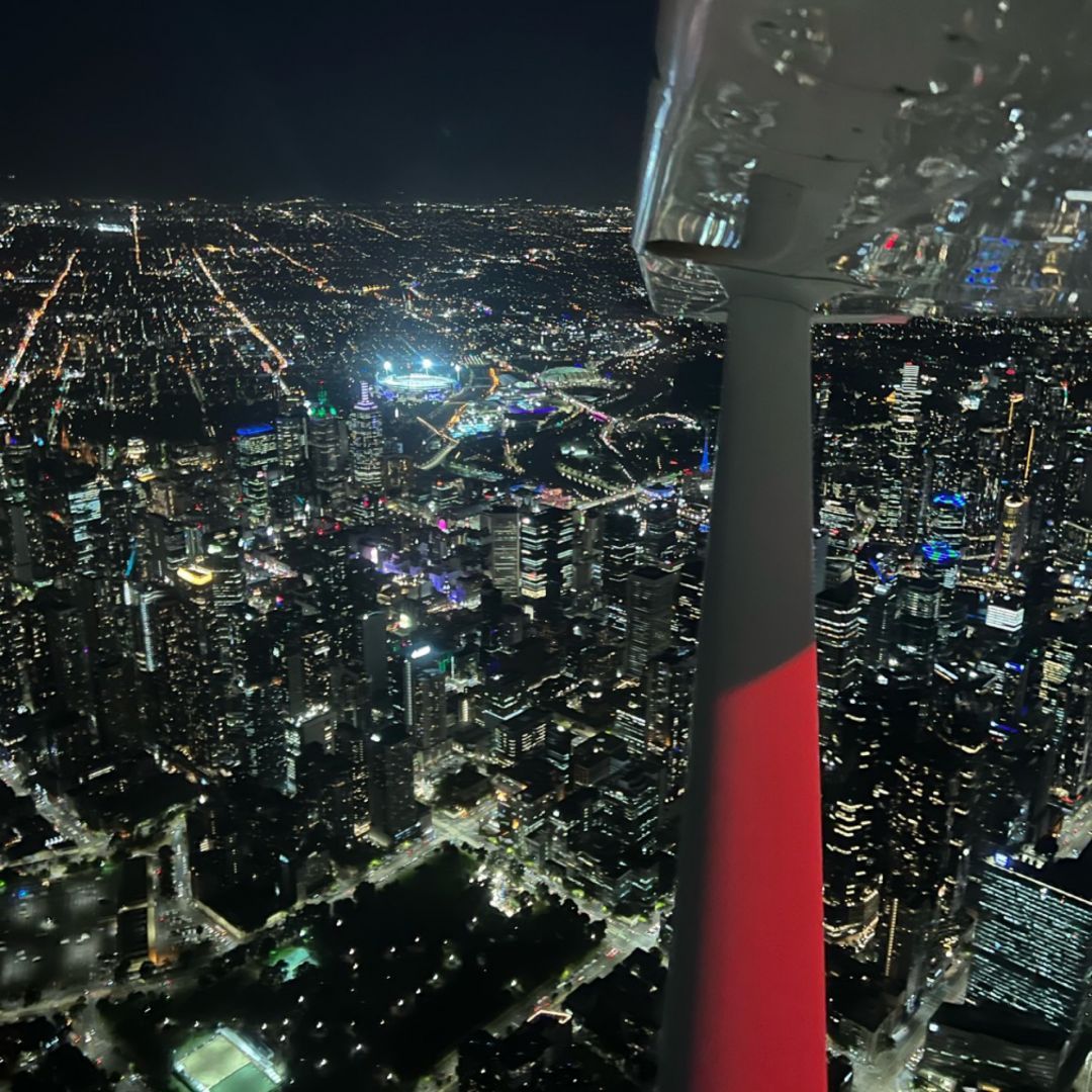 Melbourne city by night out the window of a light aircraft