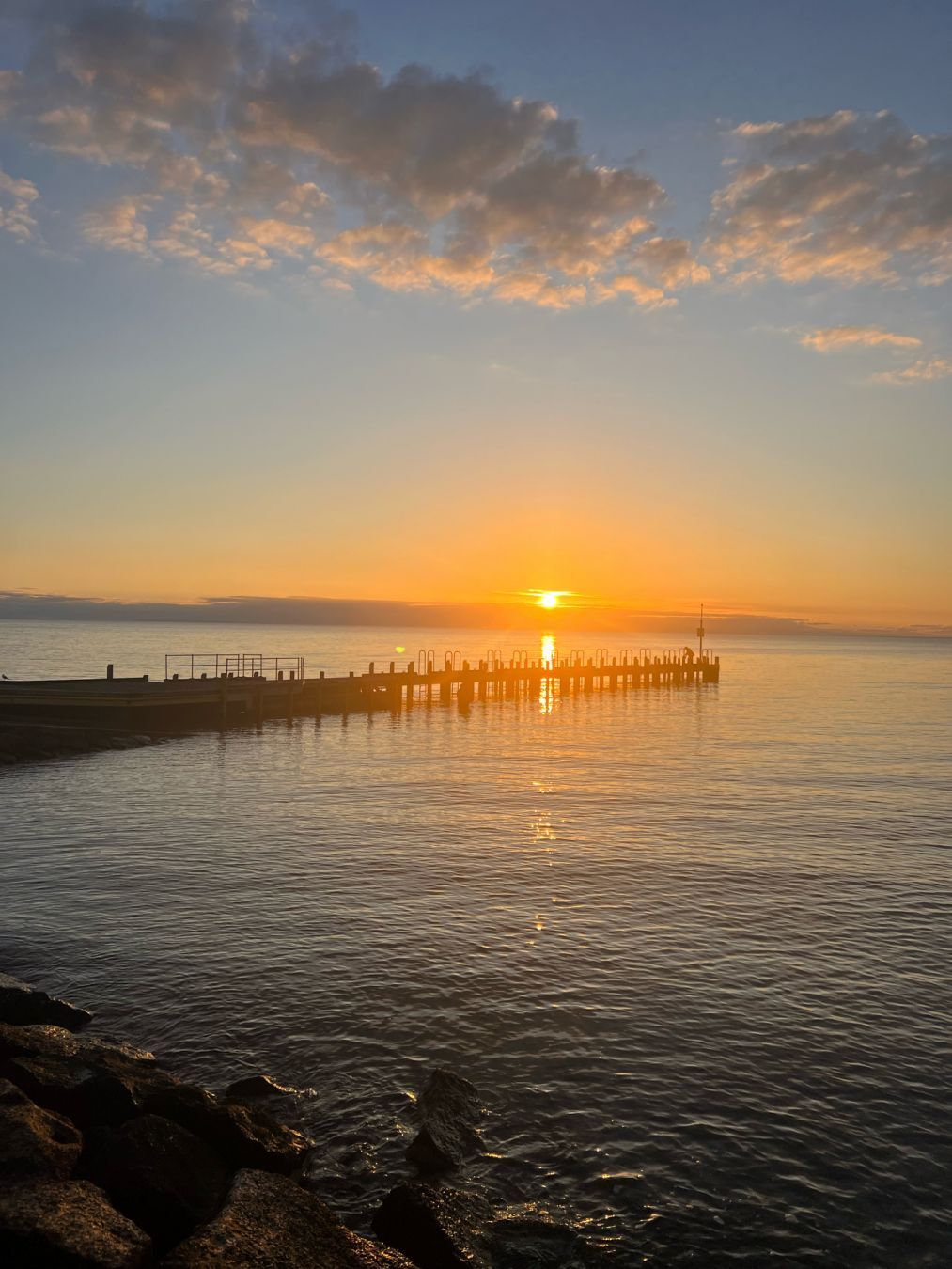 Photo of a golden sunset over the water