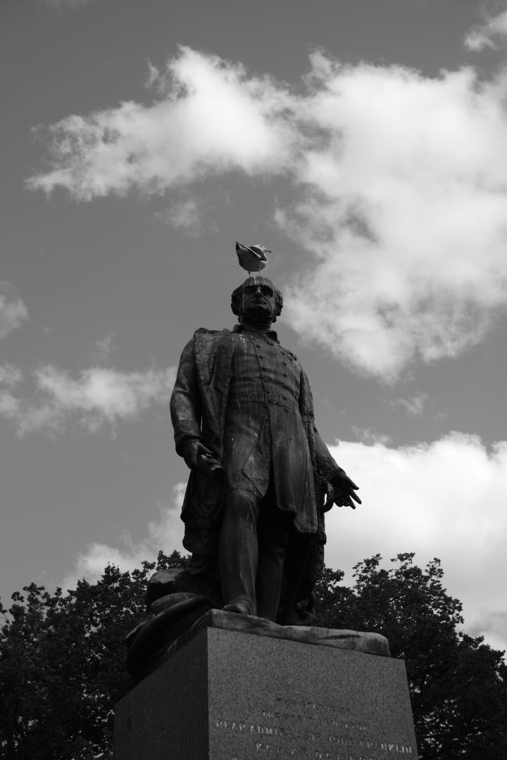 A bird on top of a statue