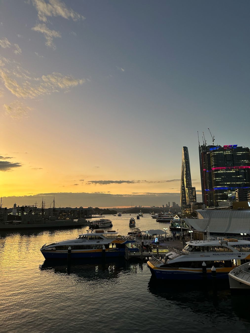 Small ferries in the foreground, looking north, Barangaroo to the right, sunset sky towards the right but facing north